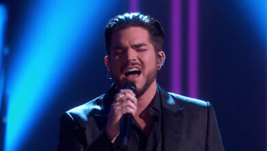 Edited illustration of Adam Lambert passionately singing under blue concert lighting.