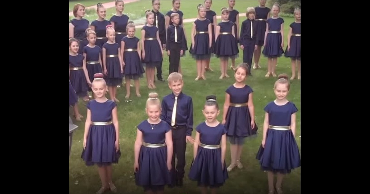 COLOR MUSIC children’s choir standing outdoors in navy outfits.