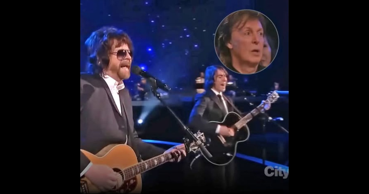Jeff Lynne and Dhani Harrison performing Something during the 2014 Beatles tribute, with Paul McCartney shown watching.