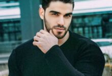 Turkish model Firat Zan wearing a black sweater in an outdoor portrait