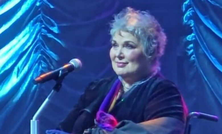 Ann Wilson seated onstage beneath blue lighting during Heart’s 2025 tour