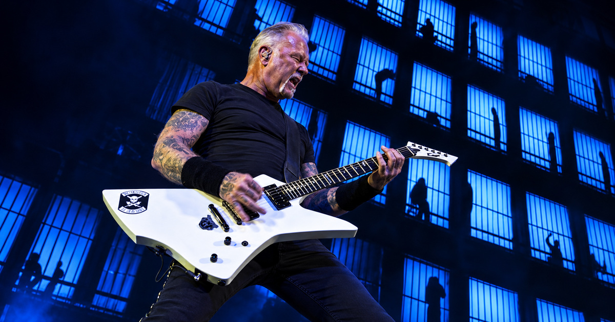 Edited image of James Hetfield playing a white guitar against blue barred-window visuals at Sphere