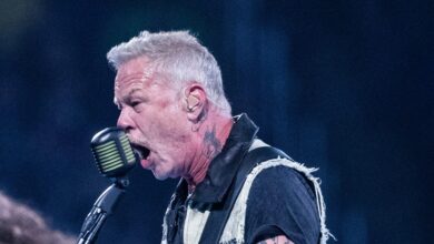 James Hetfield singing into a vintage microphone onstage