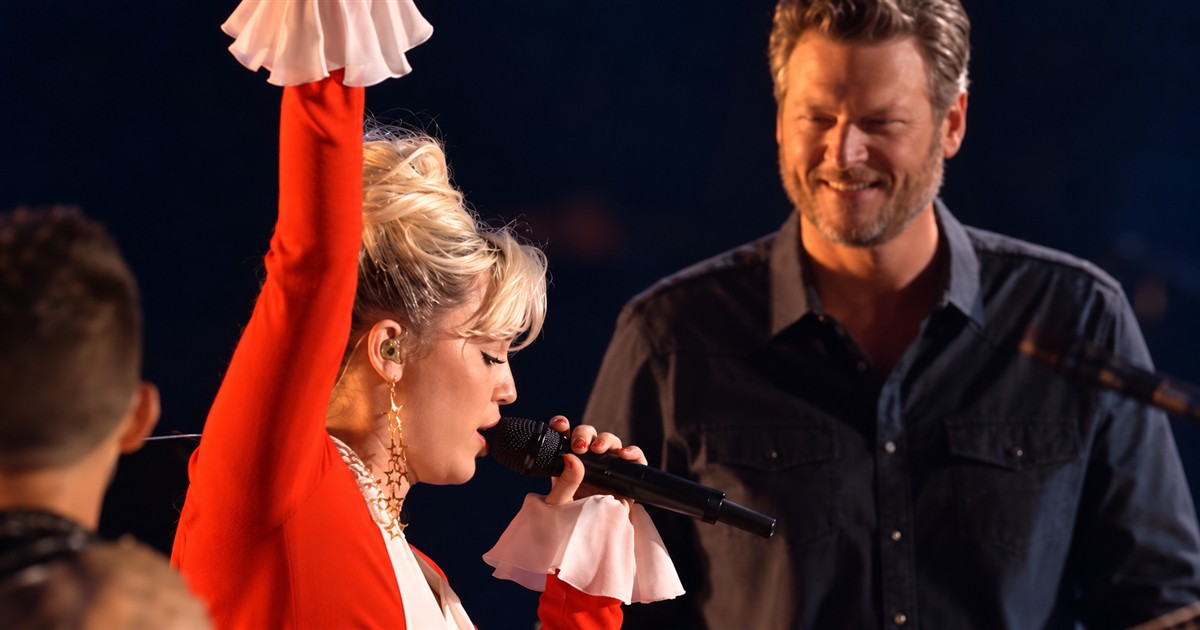 Miley Cyrus sings Dream On with one arm raised as Blake Shelton smiles behind her on The Voice